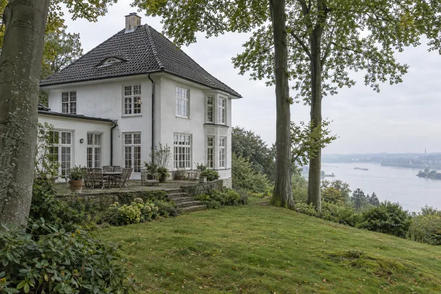 Weiße Villa mit Terrasse und altem Baumbestand am Elbhang